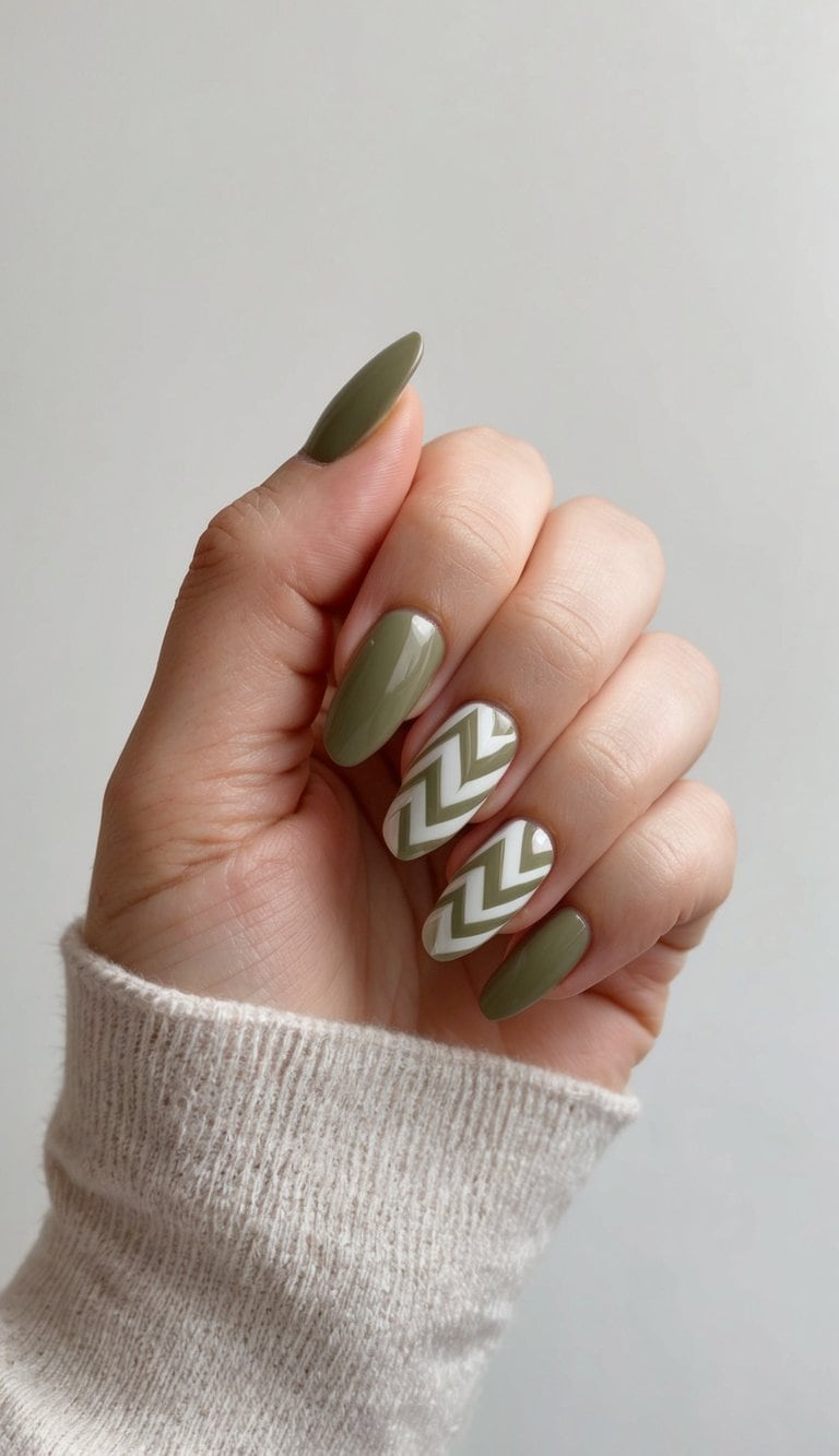 A close-up of olive and white chevron nail art designs on a neutral background