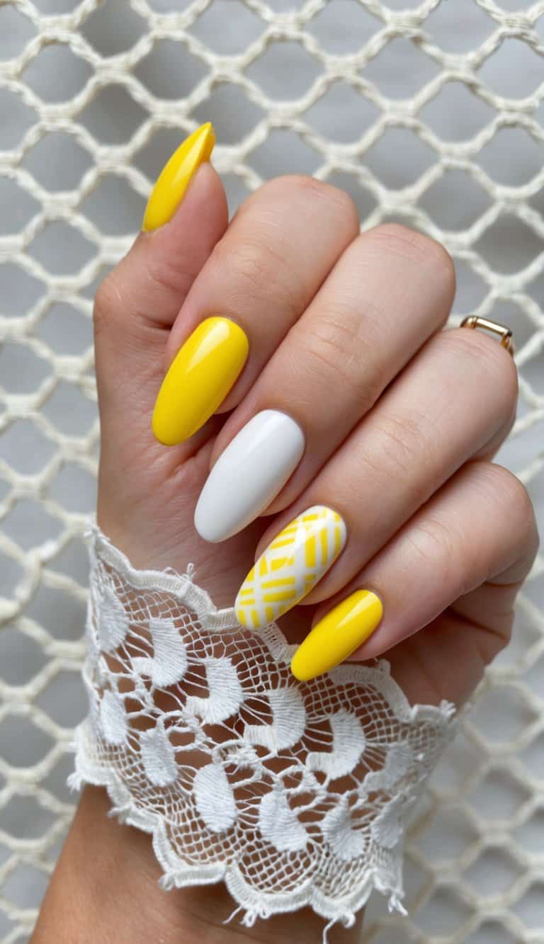 A bright yellow and white nail design on an ivory lace lattice background