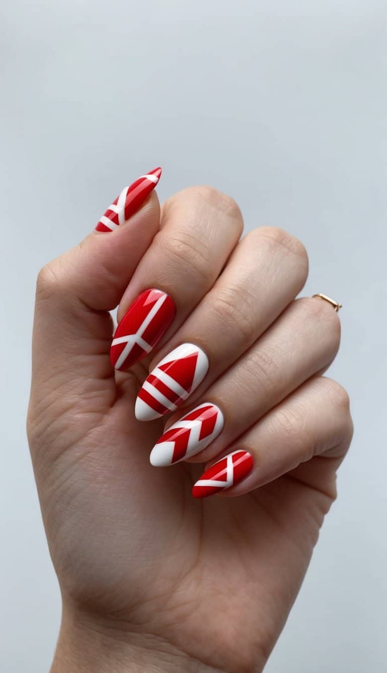 A close-up of red and white geometric triangles nail art designs