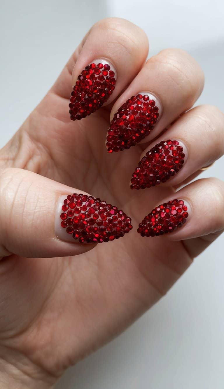 A close-up of bold red rhinestones arranged in heart shapes on a nail