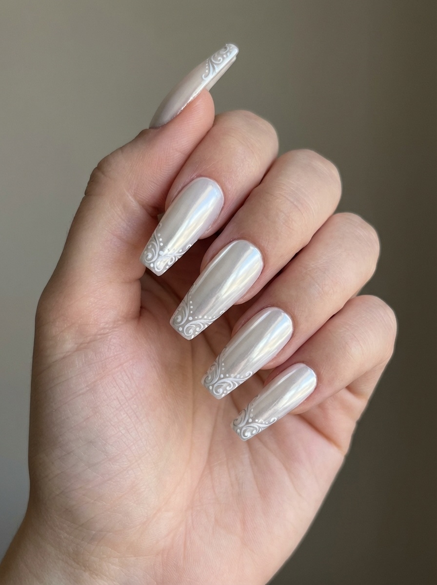 Hand shown against a soft neutral background, featuring a white chrome nail art idea with almond-shaped pearl chrome nails and intricate white swirl detailing along the tips.