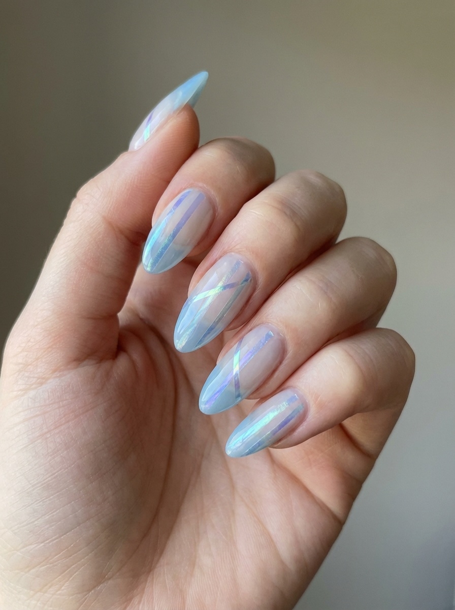 Fingers curled inward reveal translucent blue almond nails layered with reflective white sheen accents, creating depth and shine in a modern blue almond nail style idea.