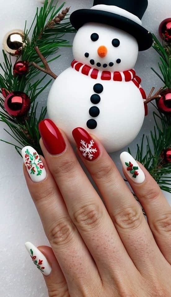 Festive red and white nails are adorned with intricate snowflakes, holly, and wreath designs, adding holiday charm. This cheerful and detailed look is perfect for embracing the spirit of Christmas celebrations.