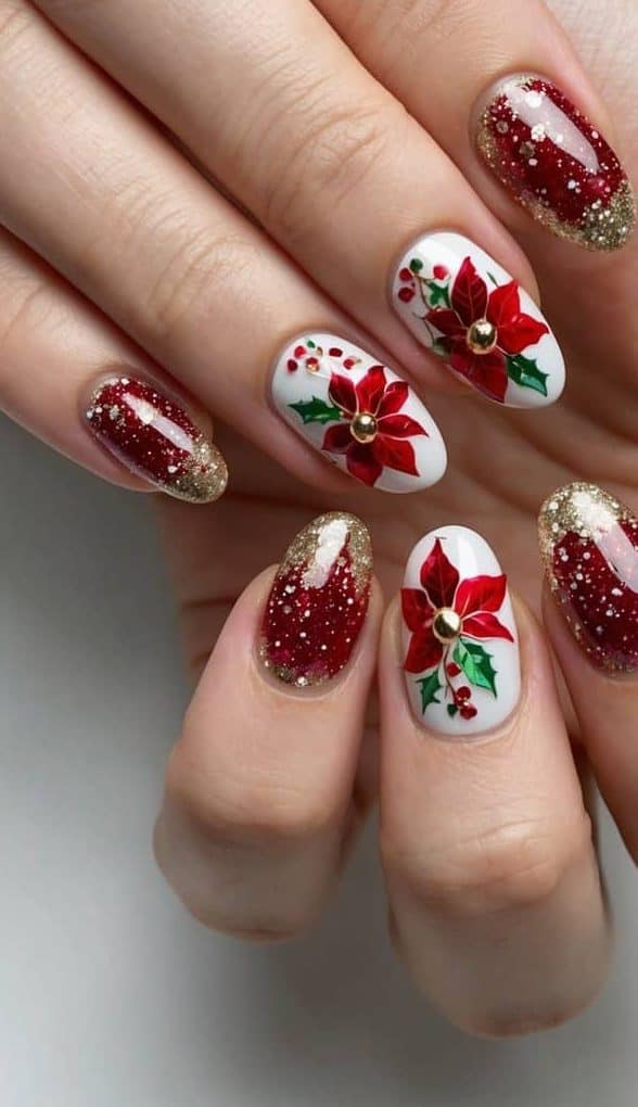 This Christmas nail art features vibrant red poinsettias on a white base paired with glittery crimson nails topped with golden accents