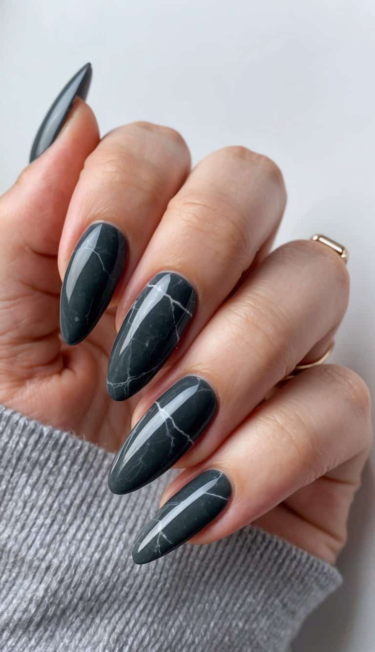 A close-up of charcoal gray marble nails arranged in a stylish and modern composition