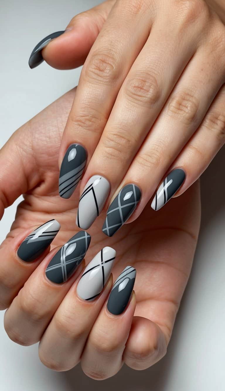 A sleek, modern nail art design featuring geometric charcoal gray patterns on a set of elegant nails