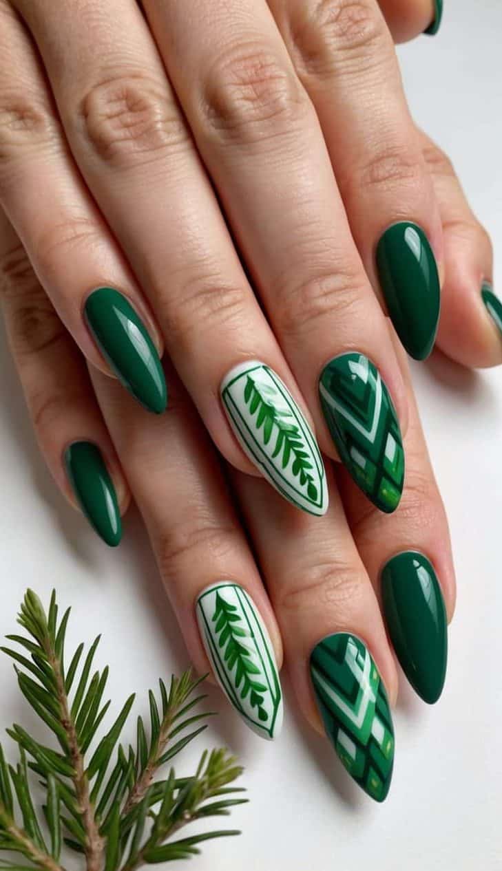 A lush green almond-shaped nail art design with geometric patterns and evergreen motifs