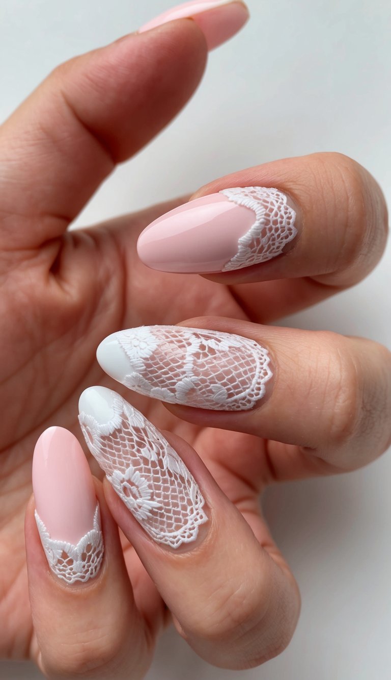 A hand with long nails featuring pale pink polish and fine white lace appliqué, offering a soft and romantic pink and white nail art idea.