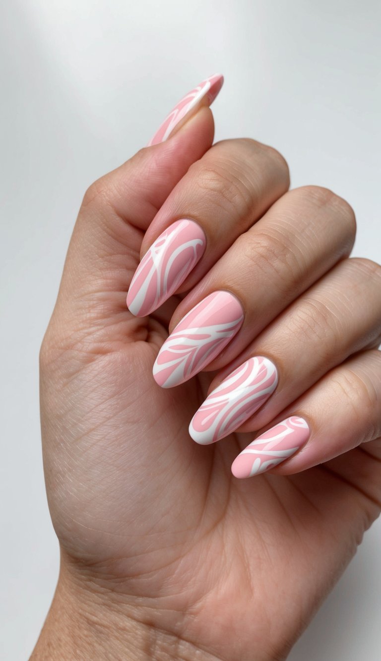 Long oval nails painted baby pink, designed with gentle freeform white lines, giving a fresh and trendy take on pink and white nail art ideas
