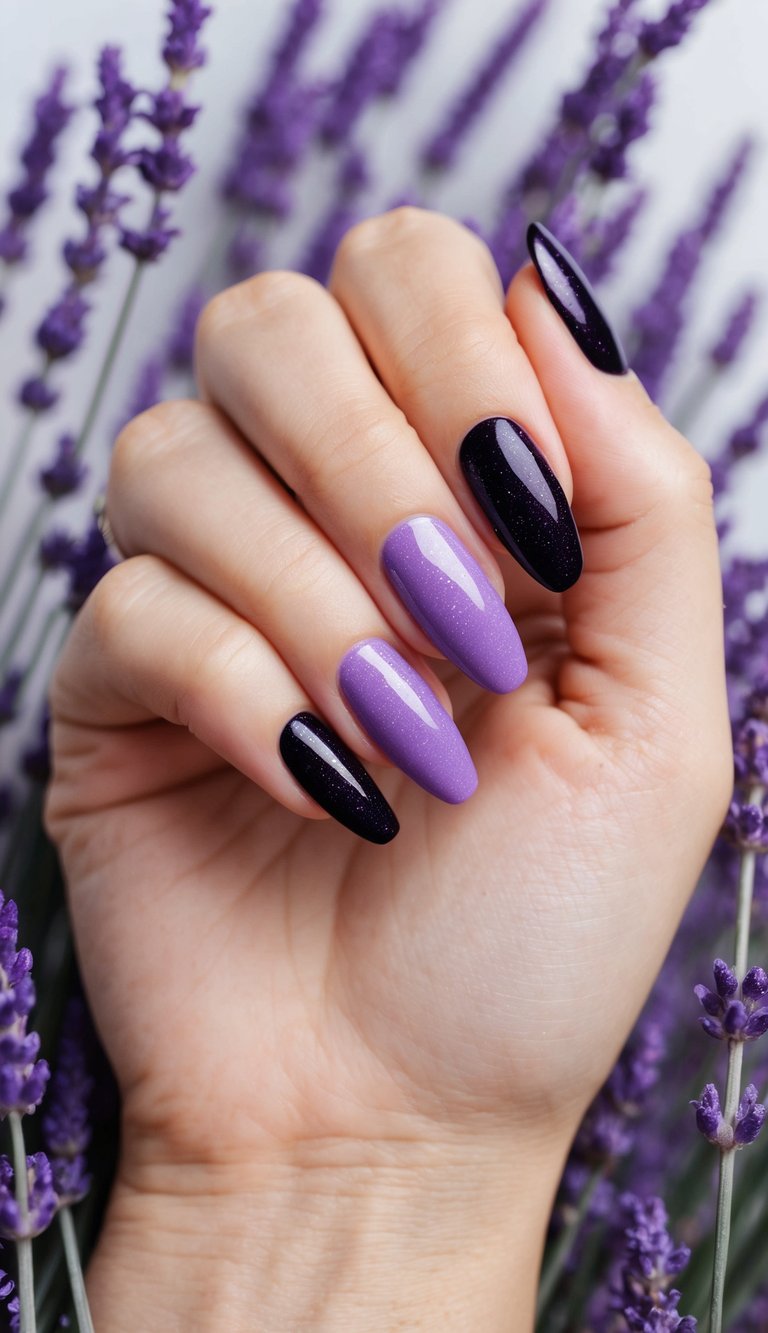 A close-up of a hand surrounded by lavender flowers reveals almond-shaped nails in soft lilac polish paired with deep black accent nails in a purple and black nail art idea.