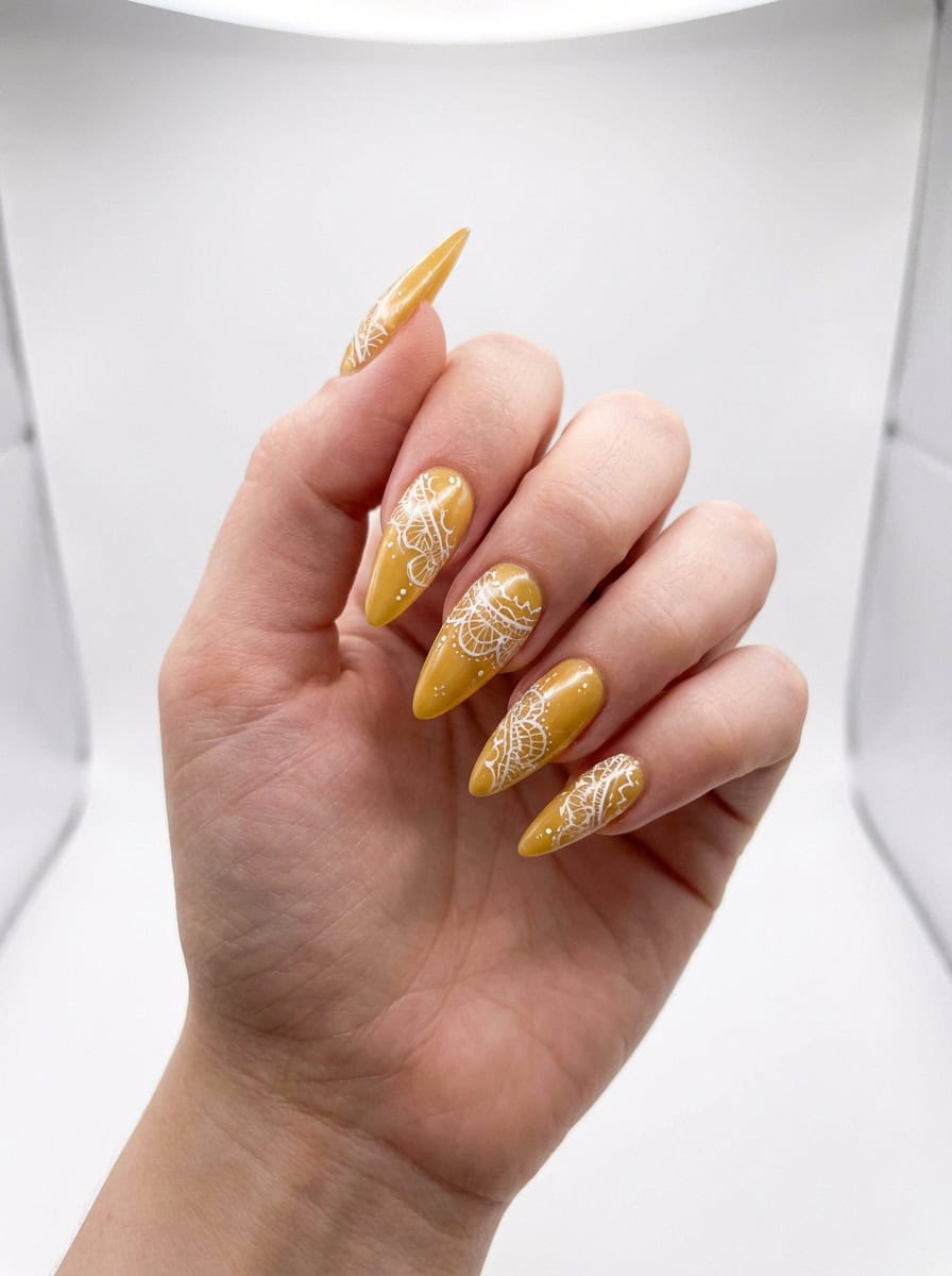 Intricate and mesmerizing, this yellow nail art idea blends warm mustard tones with mandala-style white linework, creating a balanced look that’s both soft and structured.