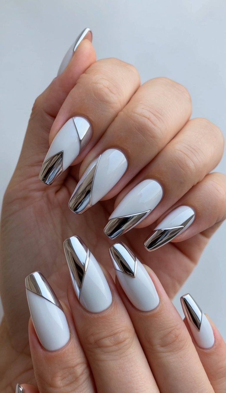 Manicured hand photographed in soft light, displaying a white chrome nail art idea with glossy white nails and sculptural silver chrome accents.
