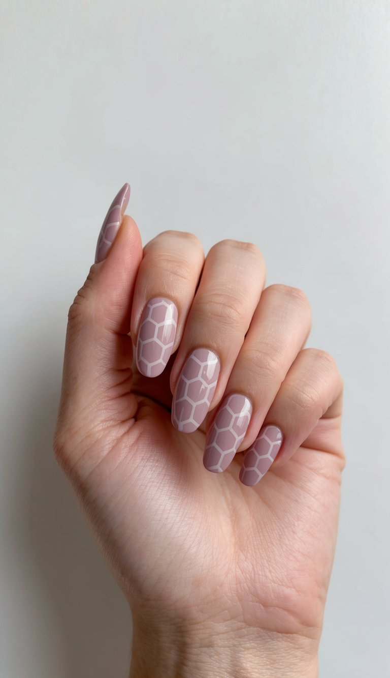 Hand posed against a neutral background showcasing a mauve nail art idea with glossy almond nails detailed in clean white hexagon geometric line patterns