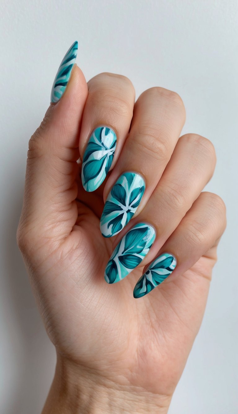 Hand held upright displaying a teal nail art idea with oversized teal flower designs and white highlights on elongated almond nails under soft natural light.