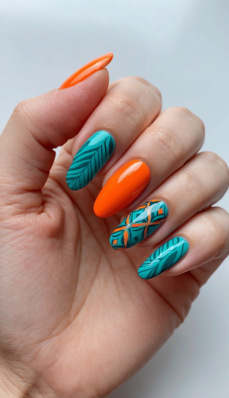 Almond manicure displaying an orange nail art idea with one bright orange nail and teal nails painted with leafy palm motifs and geometric tropical striping against a soft gray background.