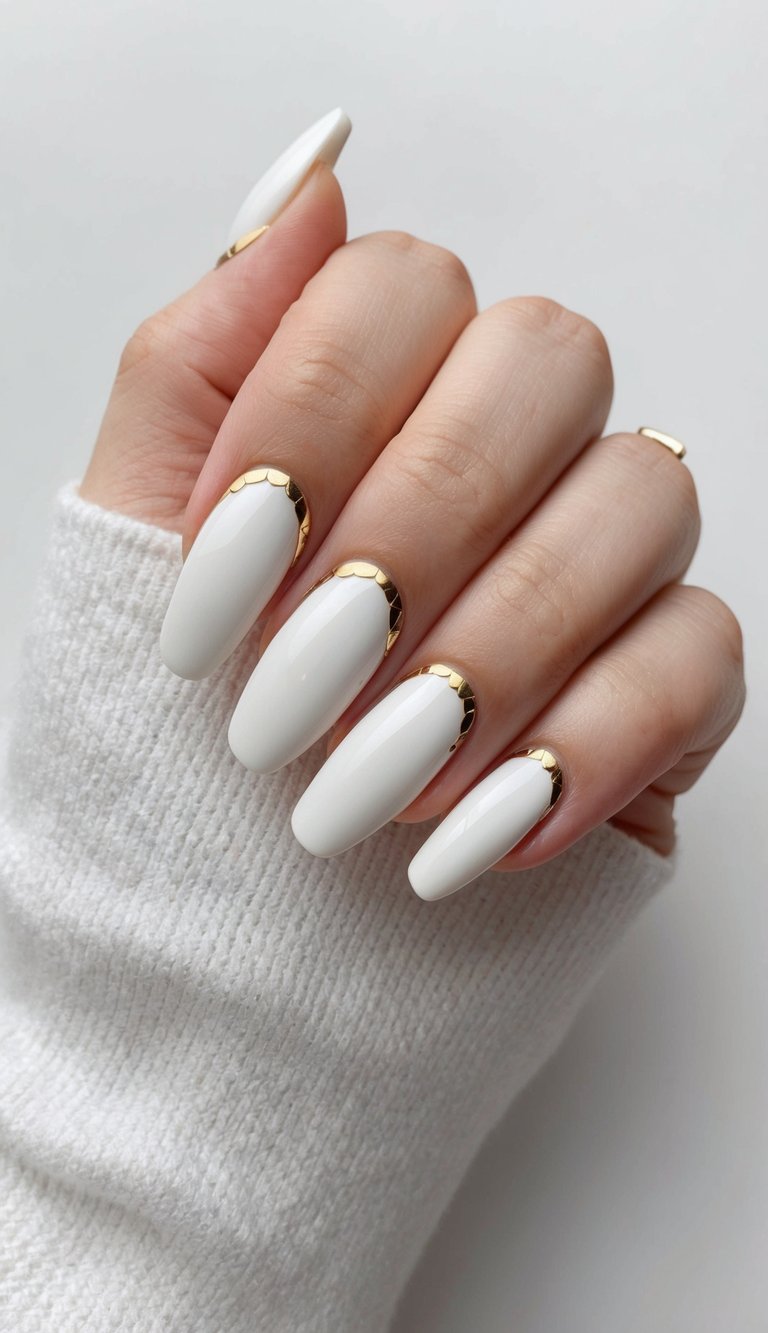 Fingers gently curled inward featuring a white and gold nail art idea with long ivory nails and delicate scalloped gold cuticle detailing against a neutral background.