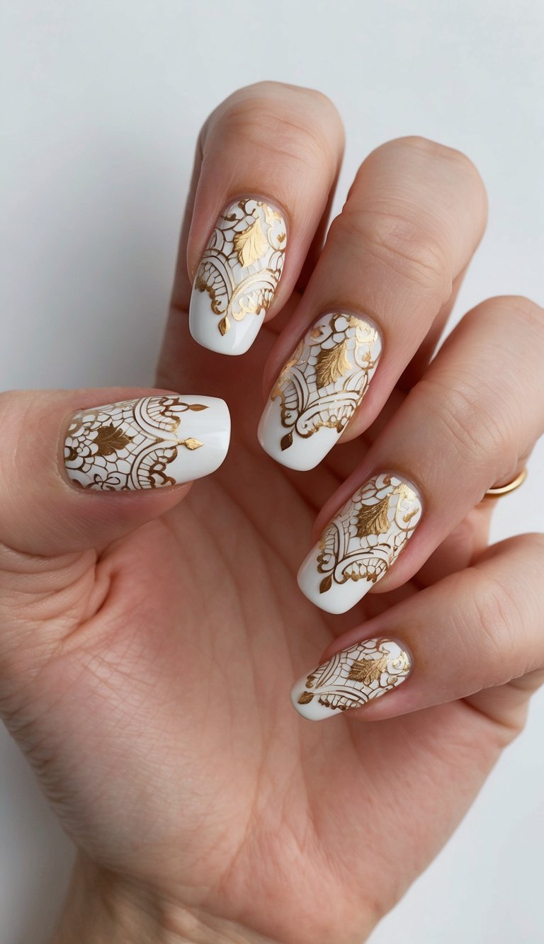 Close-up of a manicured hand showing a white and gold nail art idea with square ivory nails decorated with intricate metallic gold lace patterns across each nail.