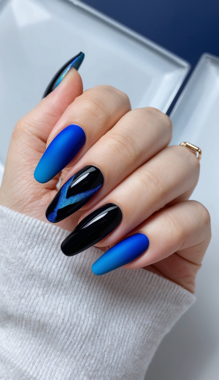 Manicured hand with long almond nails featuring a black and blue nail art idea with matte cobalt-to-blue gradient nails and glossy black nails with a metallic blue streak accent.