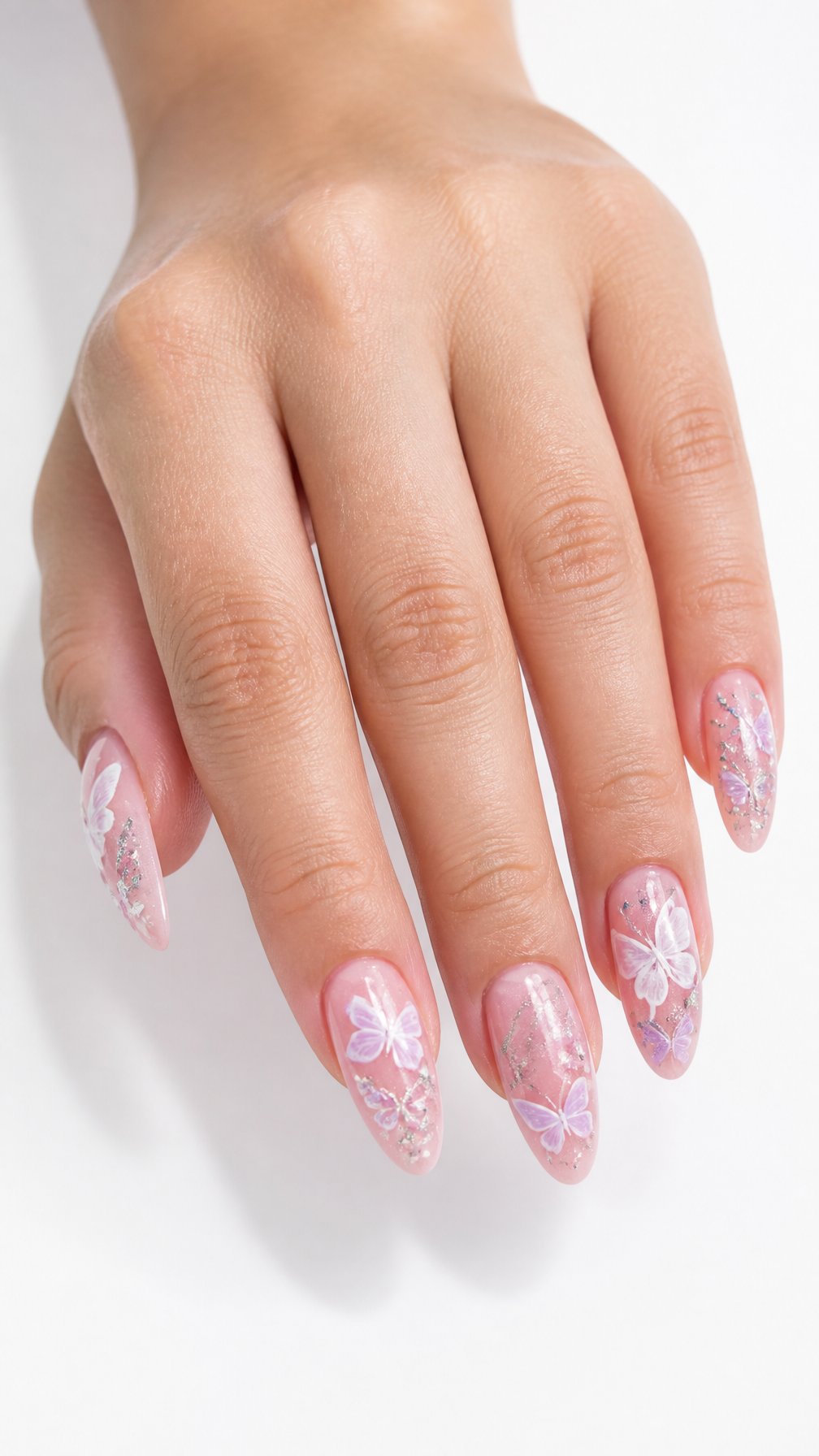 A single hand with long glossy pink nails decorated with delicate butterfly designs rests against a white background.
