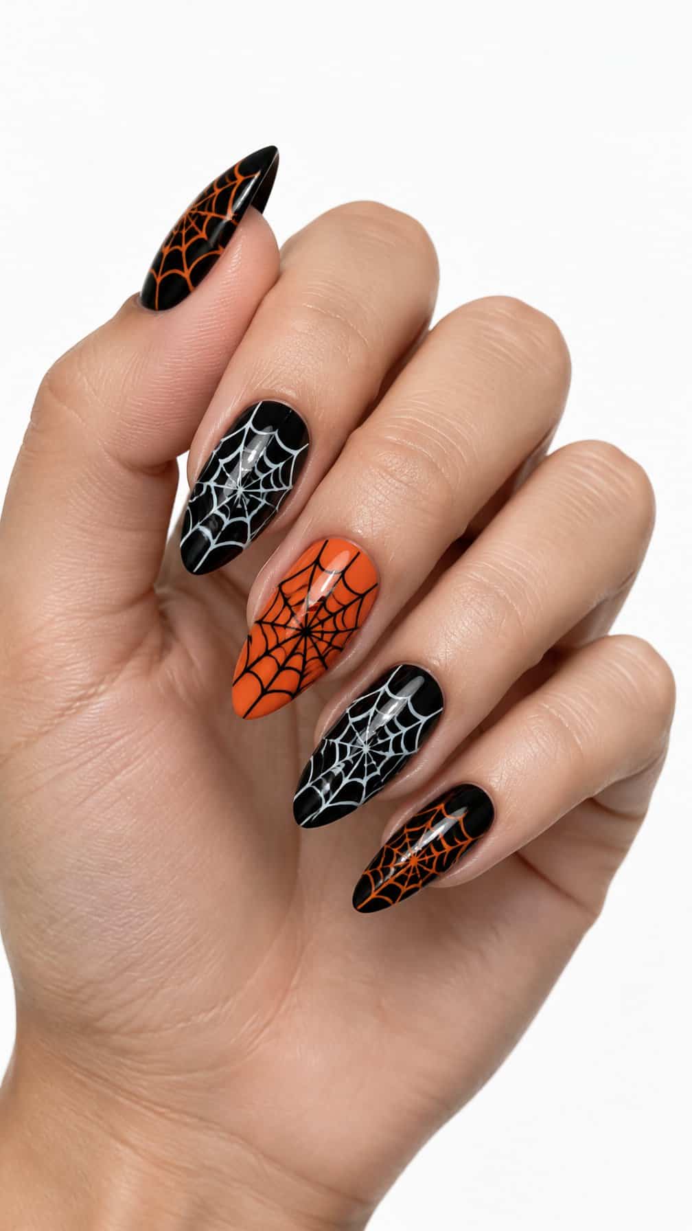 Black and orange nails decorated with delicate spider web patterns