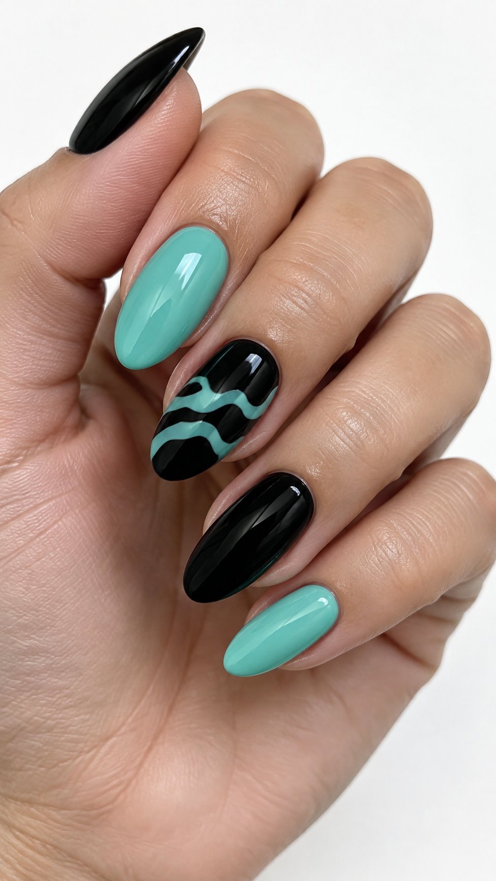 Glossy black and seafoam teal almond-shaped gel nails featuring simple wave designs