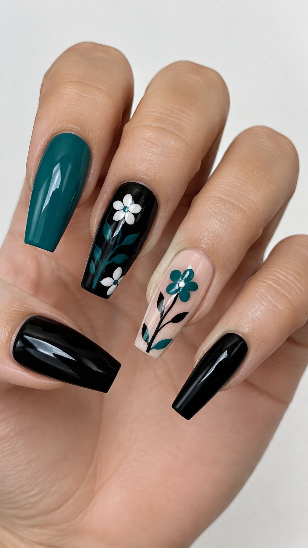 Glossy black, teal, and white floral coffin-shaped nails