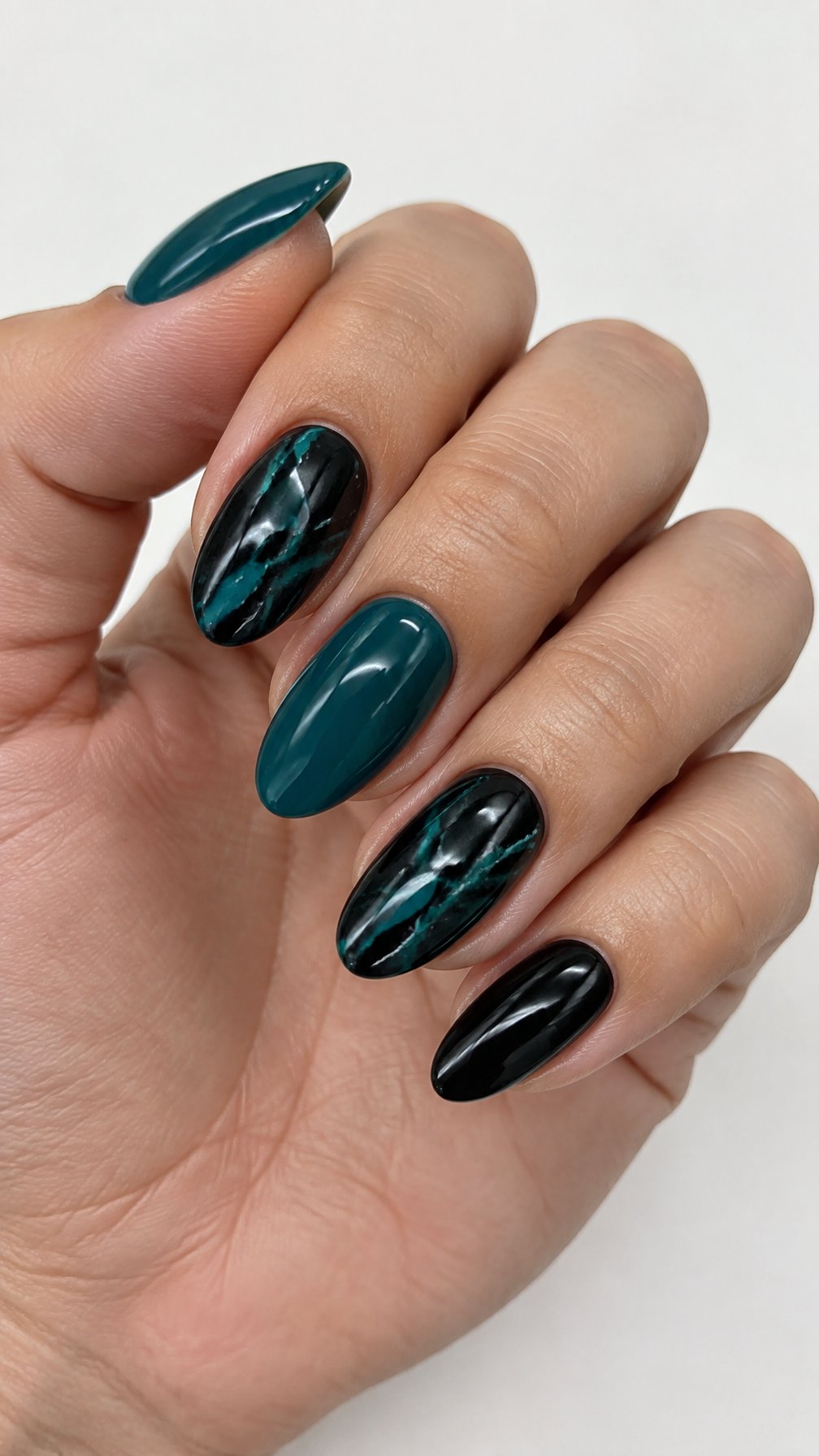 Glossy black and teal marble-patterned gel nails