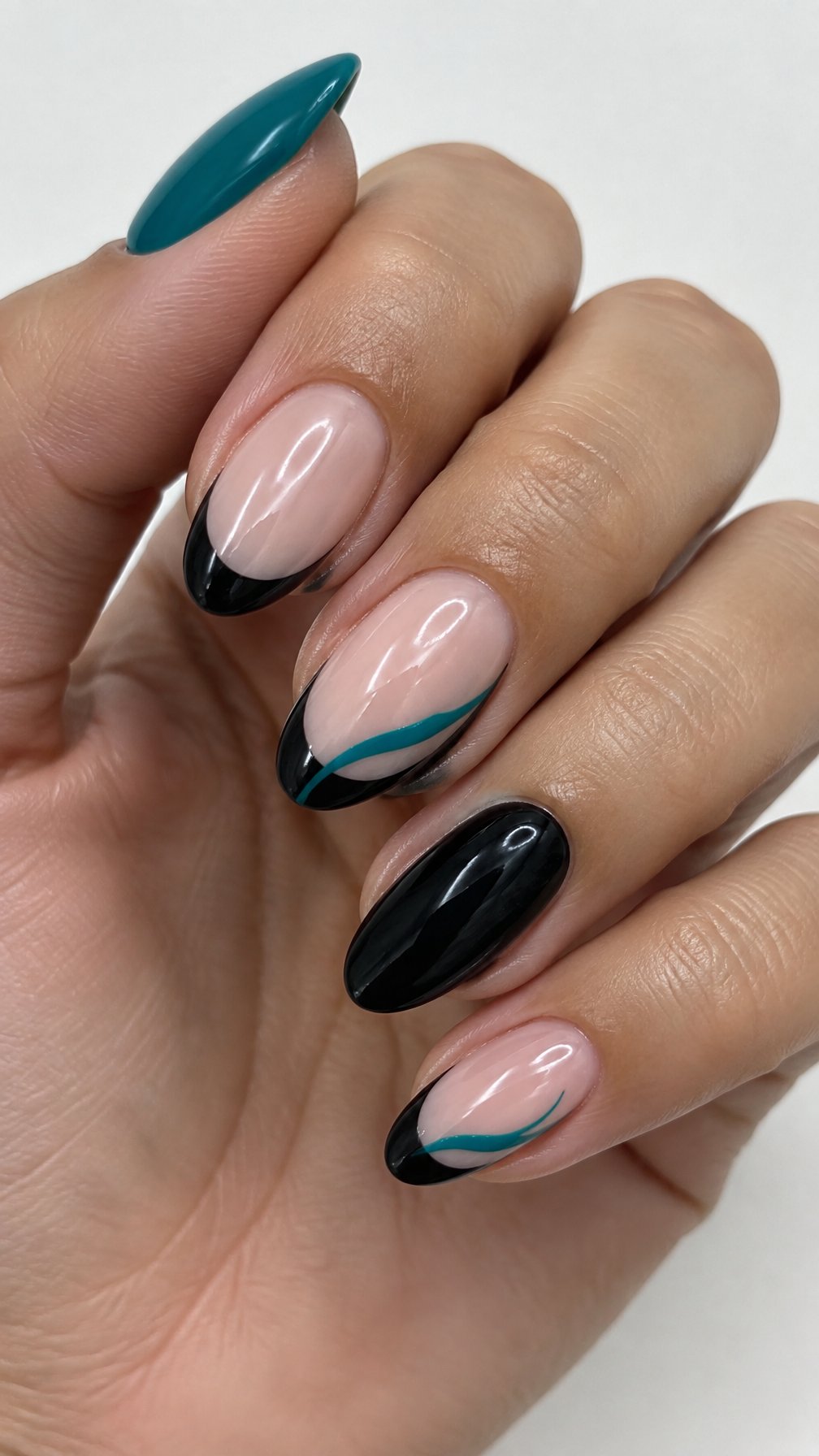 Glossy black French tip nails and teal swirl accents