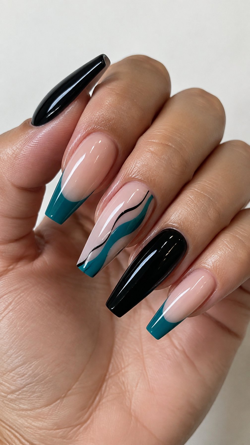 Glossy black and teal coffin-shaped gel nails