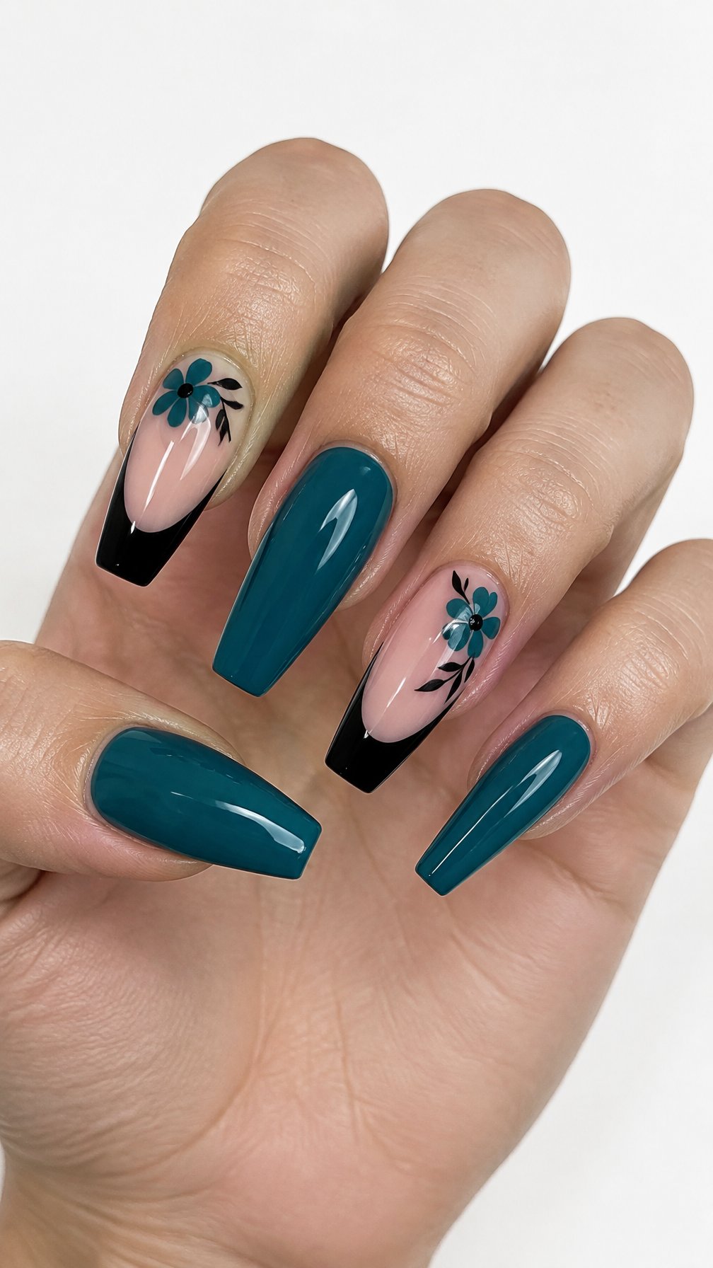 Long glossy teal coffin-shaped nails with black French tips and simple floral accents