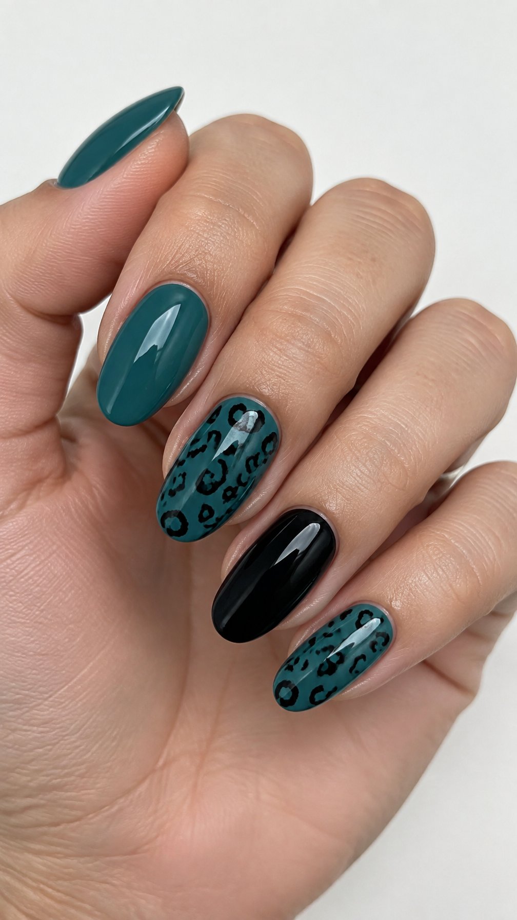 Glossy teal and black leopard-print gel nails