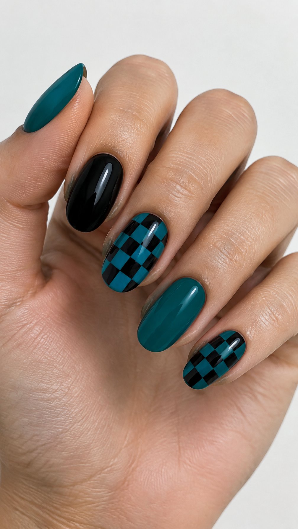 Glossy black and teal gel nails, including checkerboard accent nails