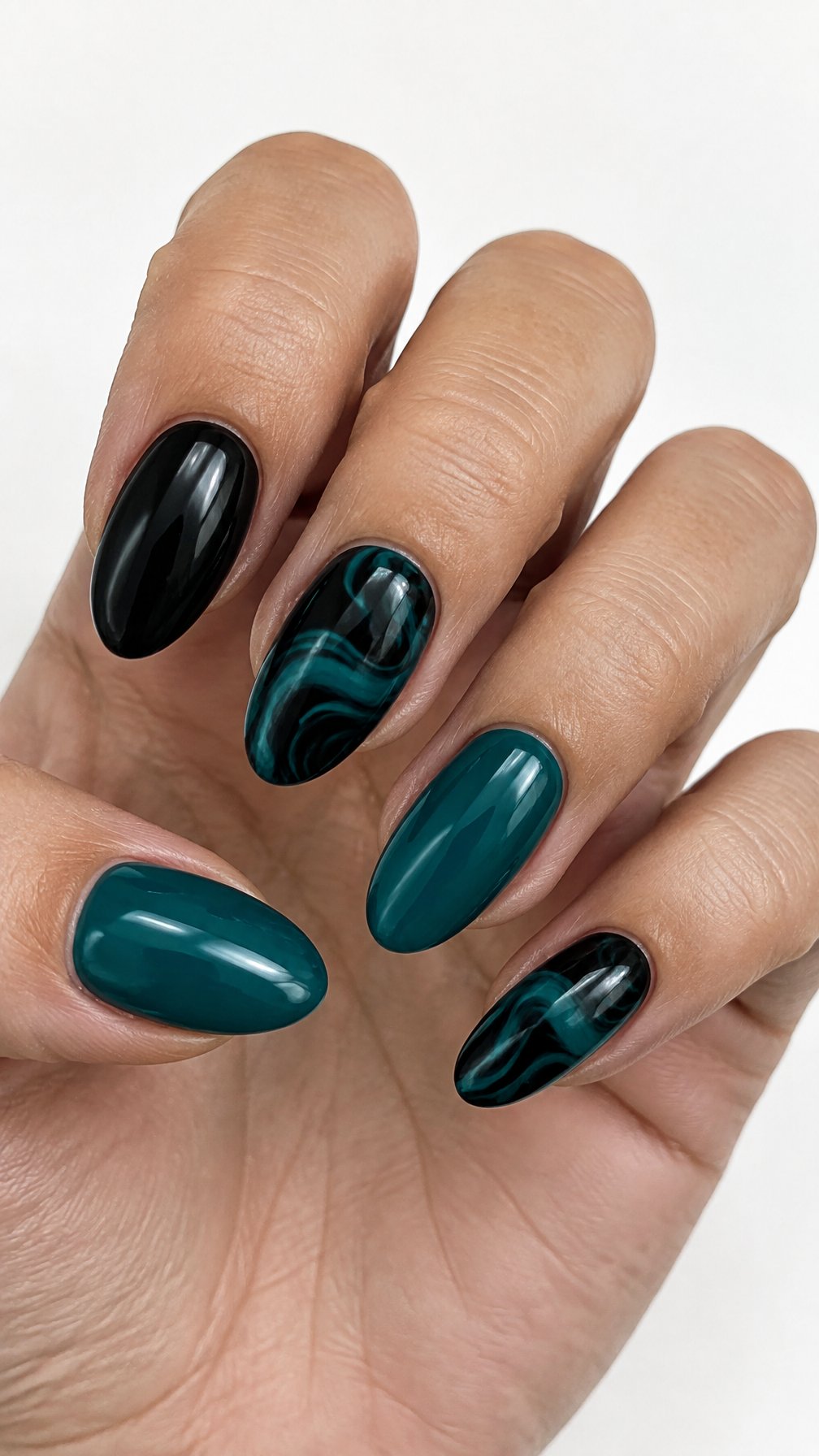 Glossy black and teal gel nails with solid-color nails and teal swirl designs