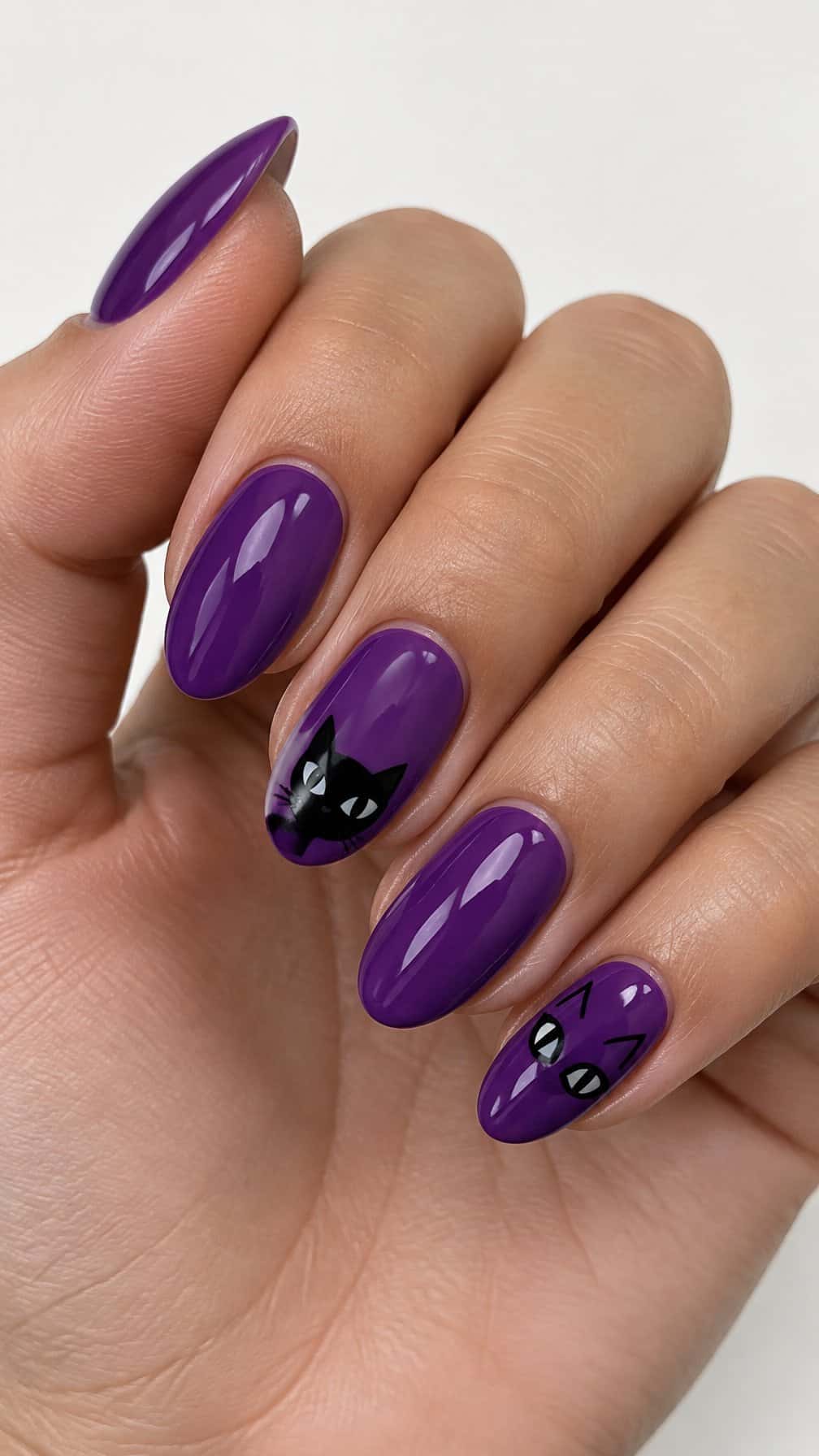 Glossy violet nails featuring small black cat designs on several nails