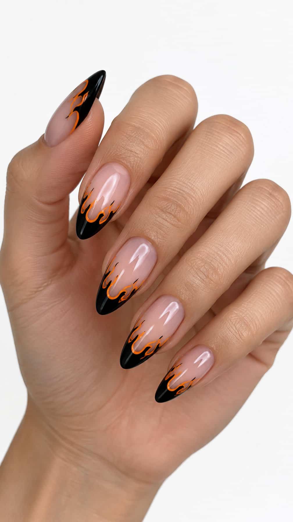 Glossy black French tip nails outlined by bright orange flames