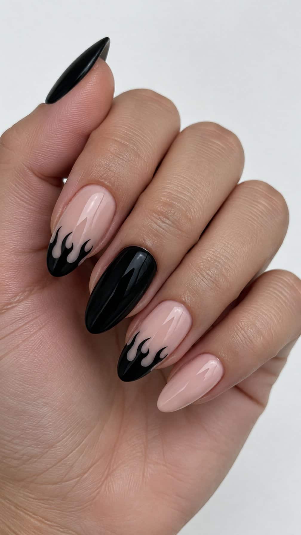 A black flame French-tip manicure