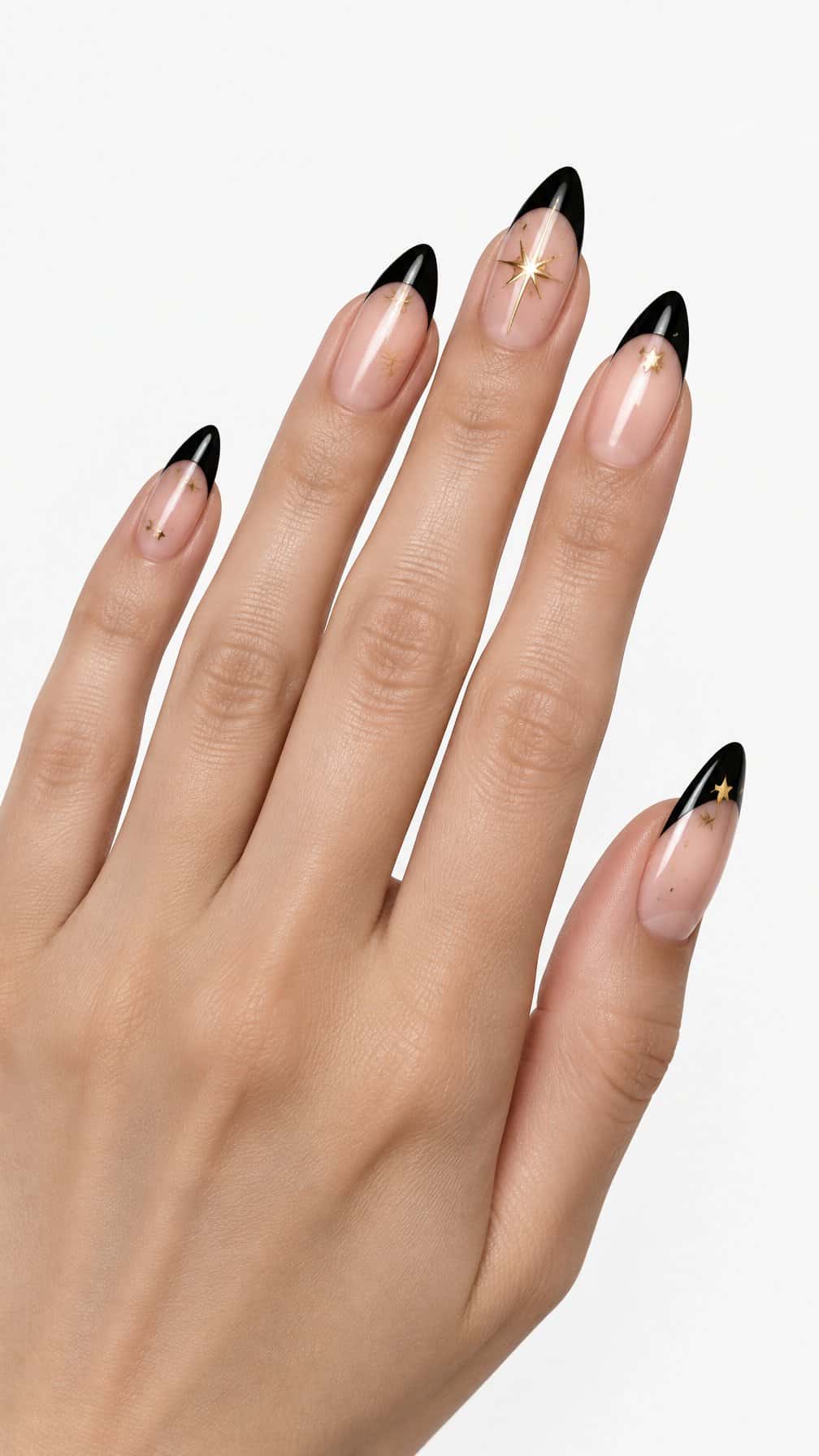 Glossy black French tip nails decorated with small gold stars
