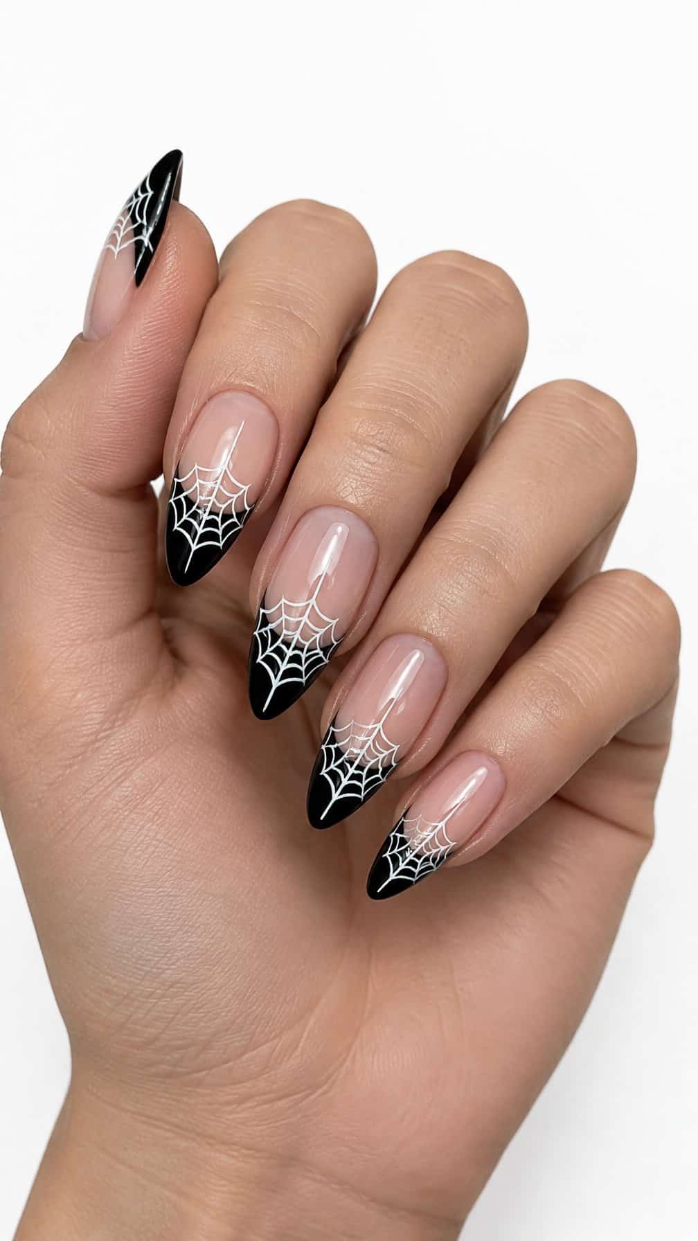 Glossy black French-tip nails decorated with delicate white spider webs