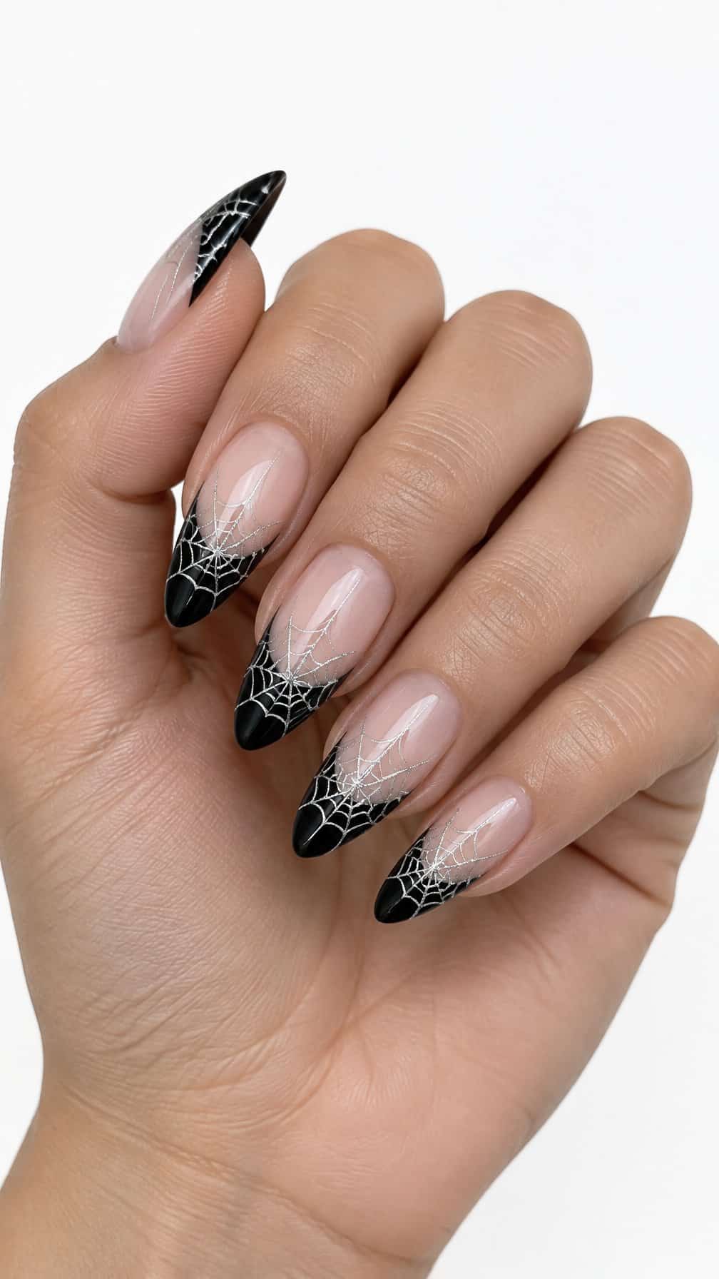 Glossy black French tip nails decorated with fine silver spiderweb designs