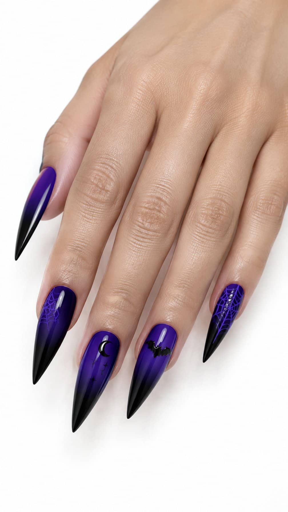 Long black and purple stiletto nails featuring delicate Halloween designs