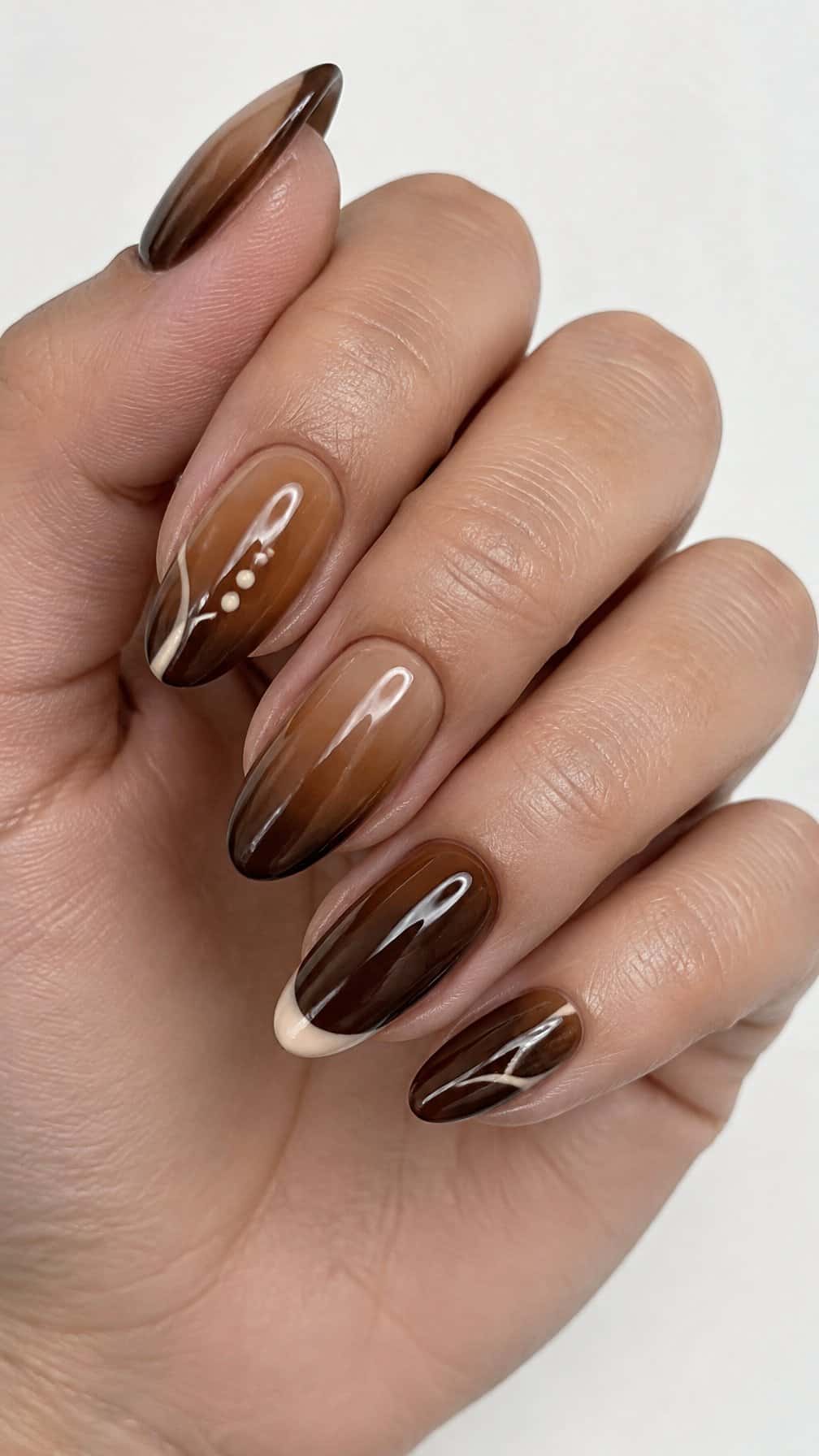 A glossy brown ombre manicure