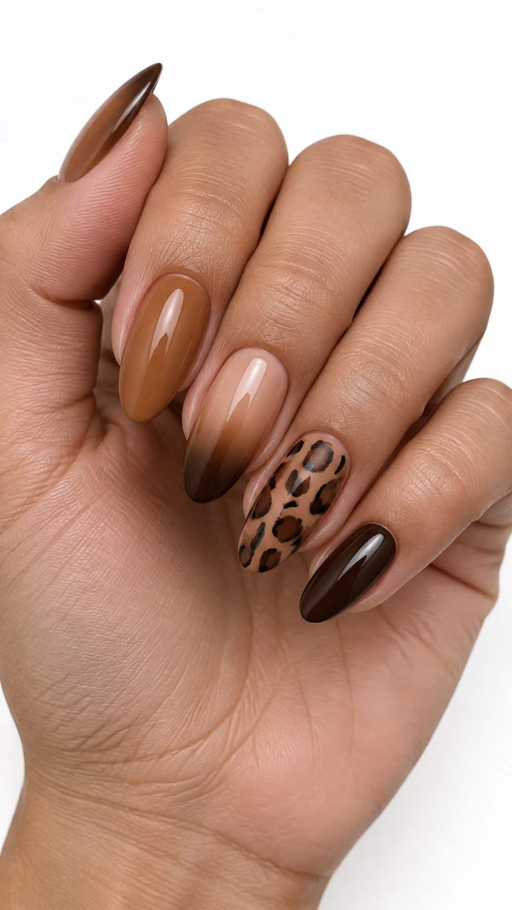 Glossy brown ombre nails and leopard-patterned accent nails