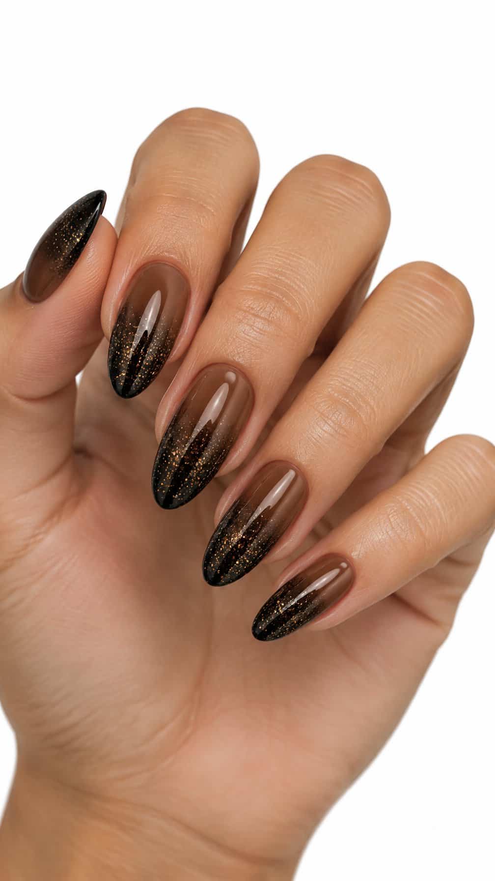 Almond-shaped nails featuring a brown-to-black glitter gradient