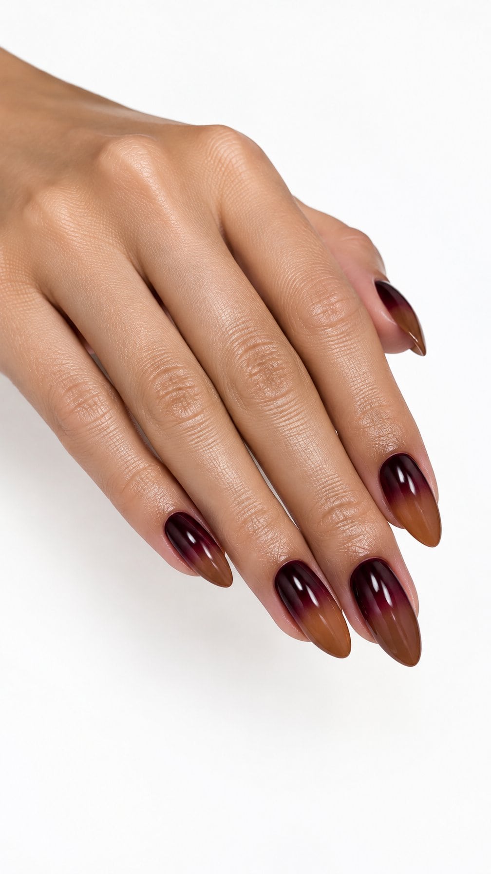 Glossy almond-shaped nails in a brown and burgundy gradient