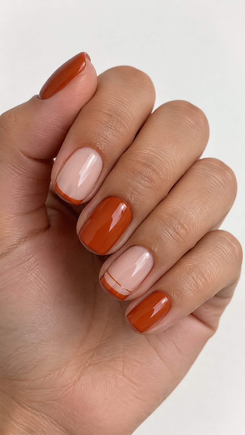 Glossy burnt-orange French-tip nails