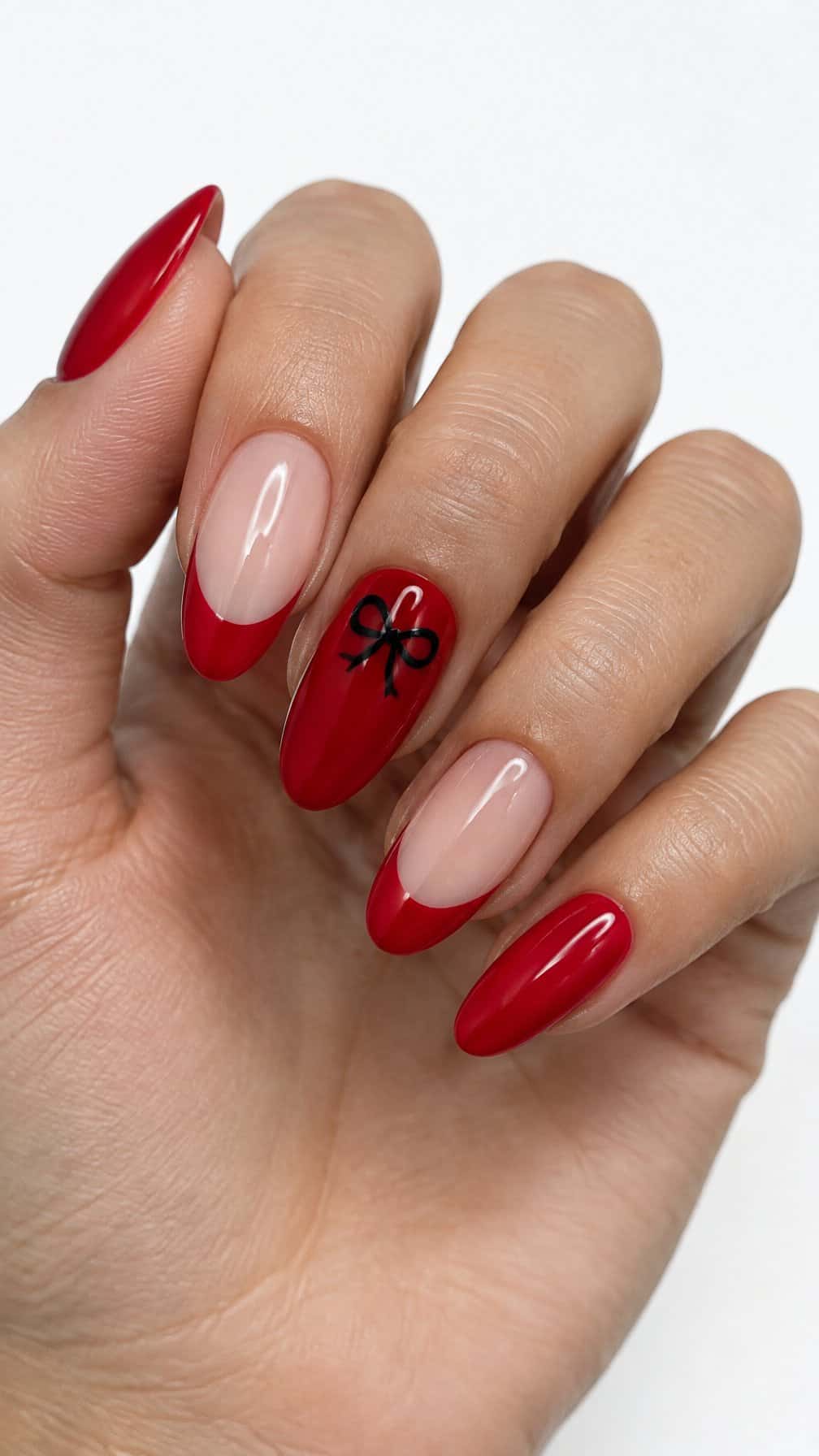 Glossy red French-tip nails and small black bow designs