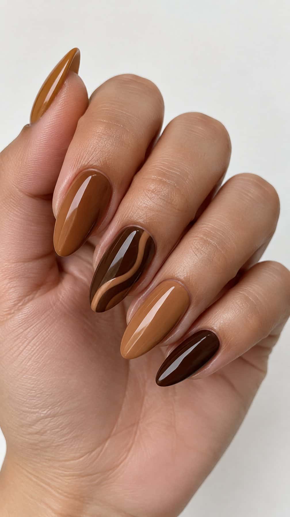 Glossy brown ombre nails and caramel swirl accents