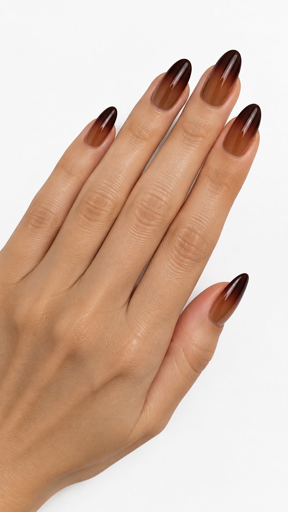 Glossy almond-shaped nails fading from caramel near the cuticles to dark espresso at the tips