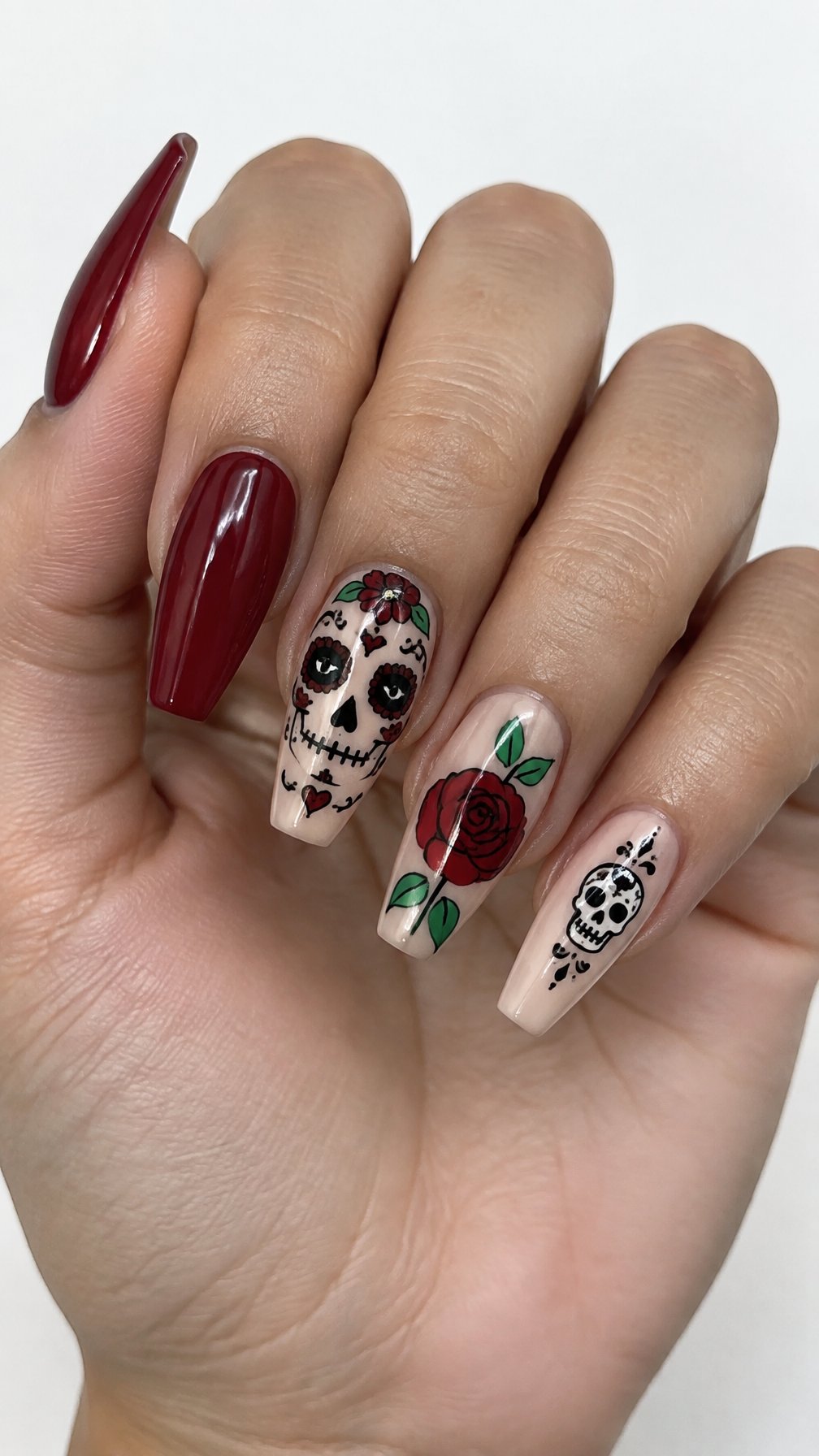 Glossy coffin-shaped nails featuring colorful skull and rose designs