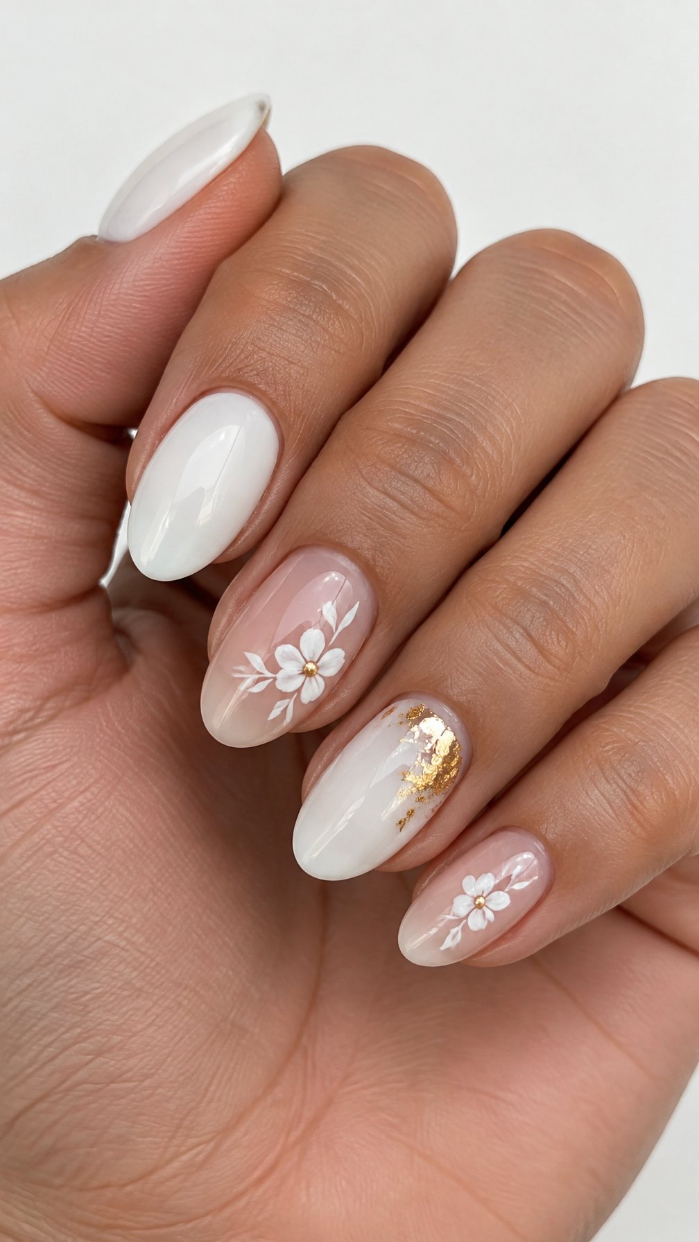 Glossy white and gold floral manicure